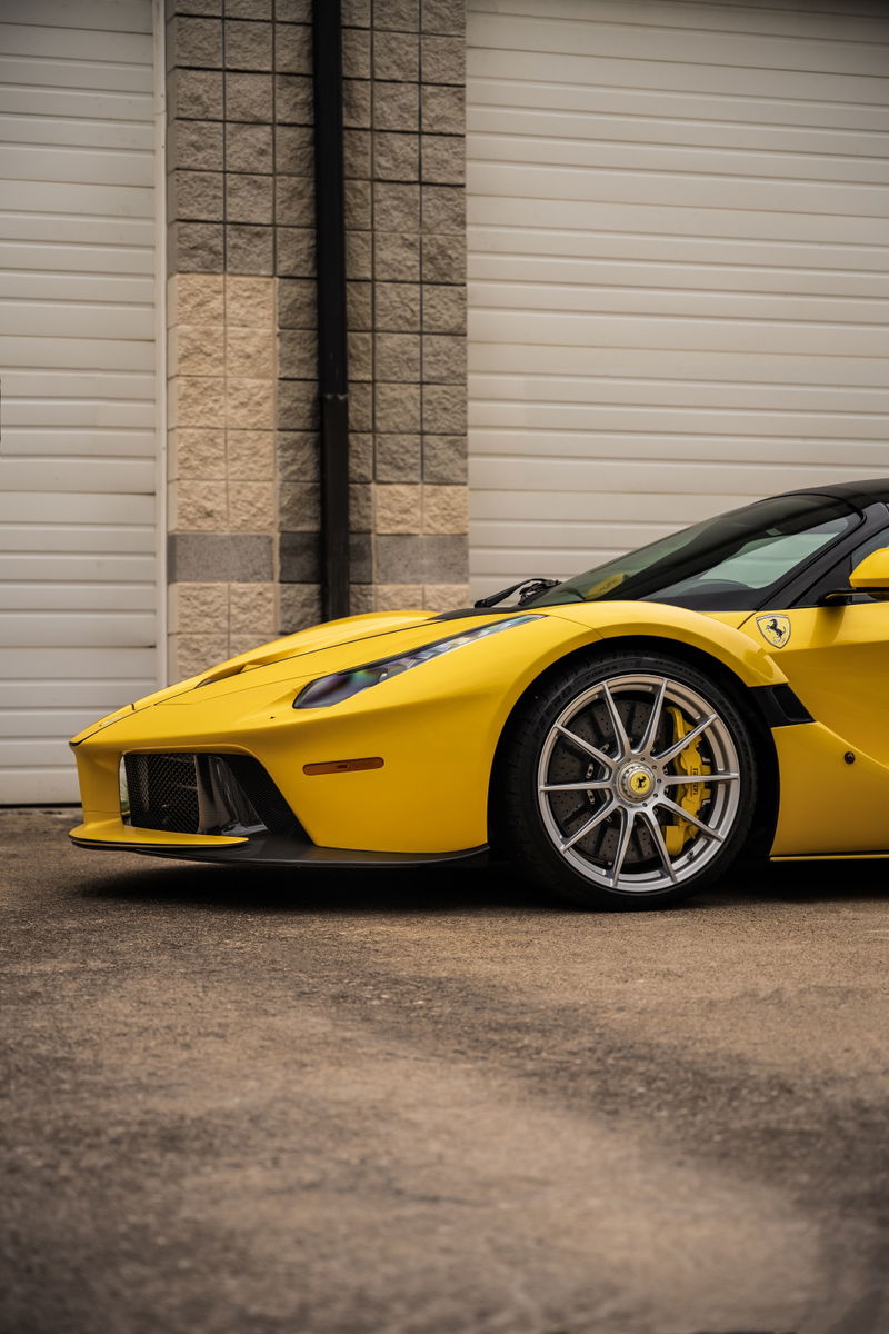 Yellow Ferrari LaFerrari Aperta with silver rims, yellow calipers, and black trim.