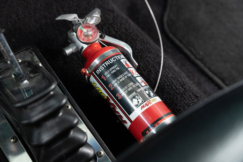 Red fire extinguisher inside a 1968 Chevrolet C10 Pro-Street.