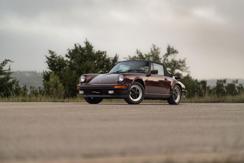 Ruby Red Metallic 1983 Porsche 911 SC Cabriolet on alloy rims.