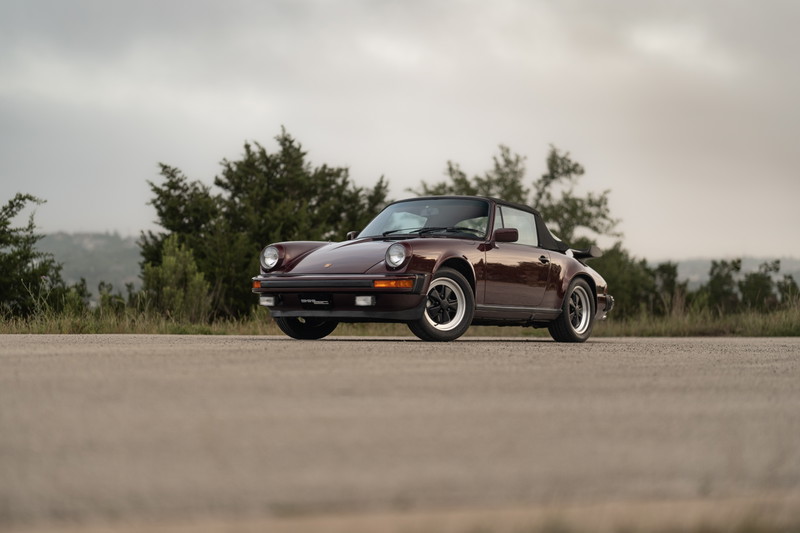 Ruby Red Metallic 1983 Porsche 911 SC Cabriolet on alloy rims.