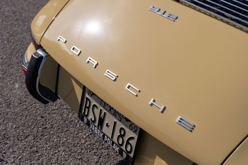 Champagne yellow 1969 Porsche 912 coupe rear emblem and license plate.