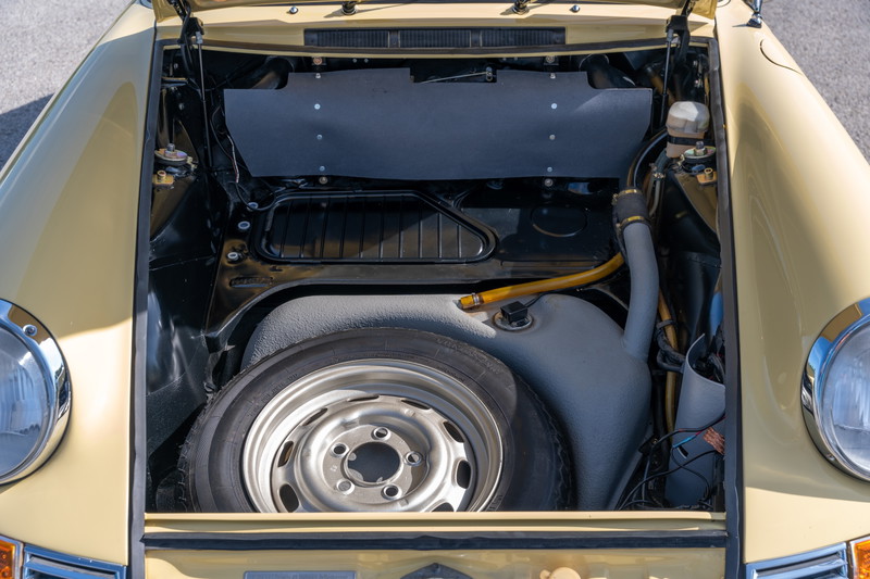 Champagne Yellow 1969 Porsche 912 coupe front trunk with spare tire and fuel tank.