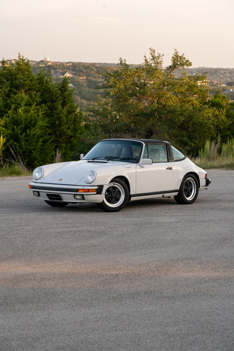 1987 Porsche 911 Carrera Targa in Marble Grey with black trim and Fuchs wheels.