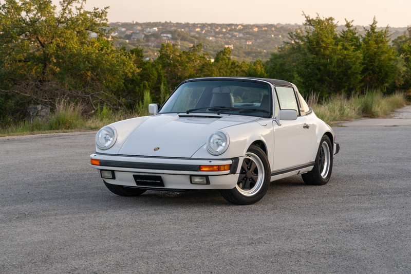 White 1987 Porsche 911 Carrera Targa with black Fuchs rims and Targa trim.