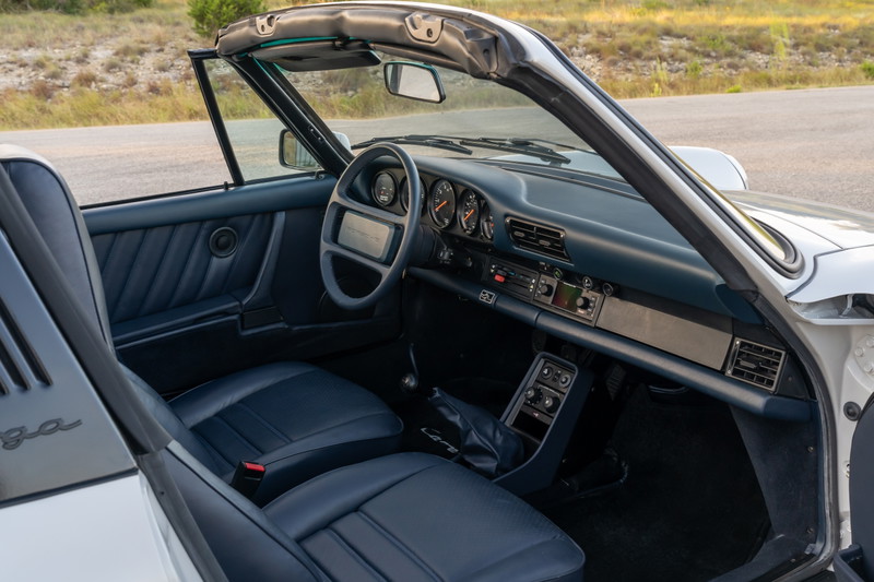 1987 Porsche 911 Carrera Targa interior with dark blue leather seats and dashboard.