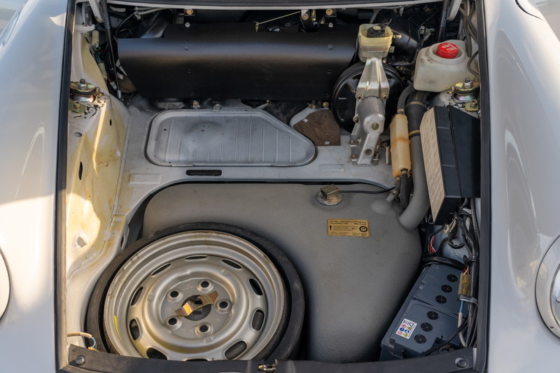 1987 Porsche 911 Carrera Targa spare rim and engine bay components in Marble Grey.