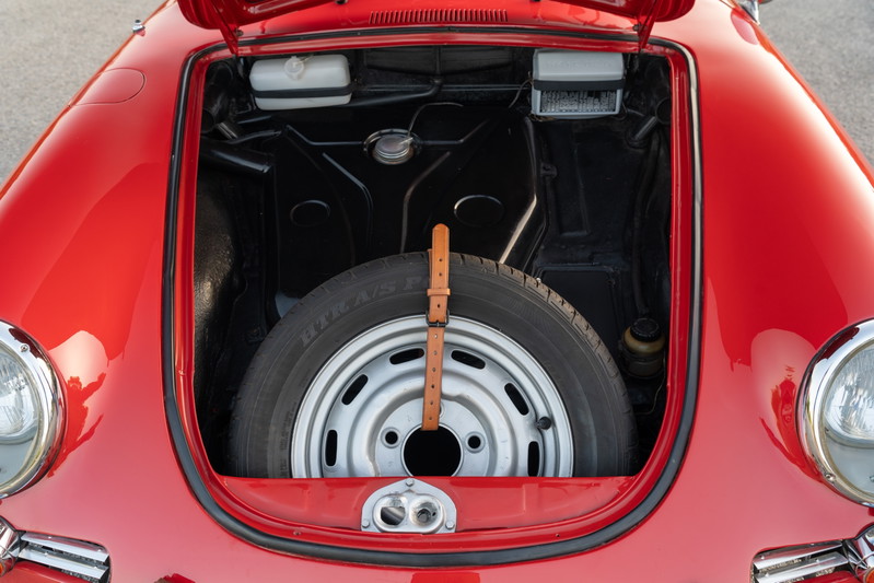 1965 Porsche 356C in Signal Red with spare tire and silver rim in front trunk.