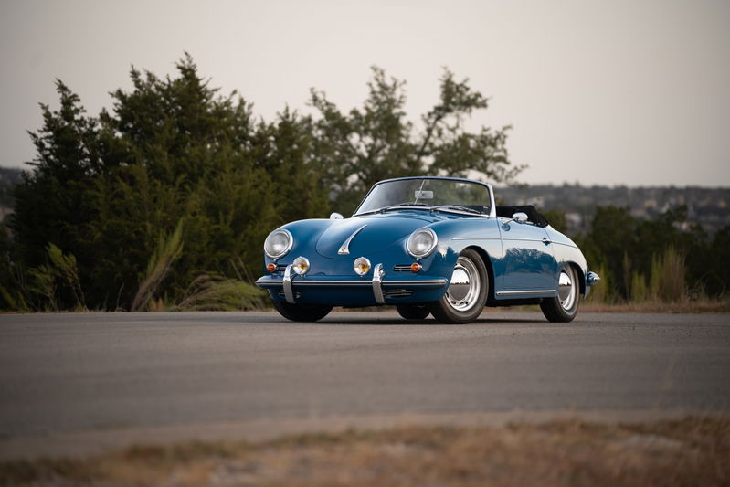 Royal blue 1960 Porsche 356B Roadster with chrome trim and hubcaps.