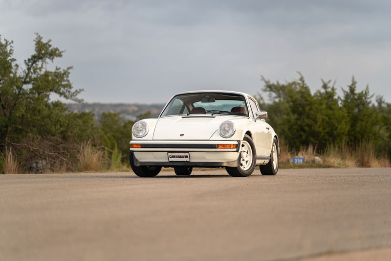White 1974 Porsche 911 Coupe with chrome trim and Fuchs wheels.