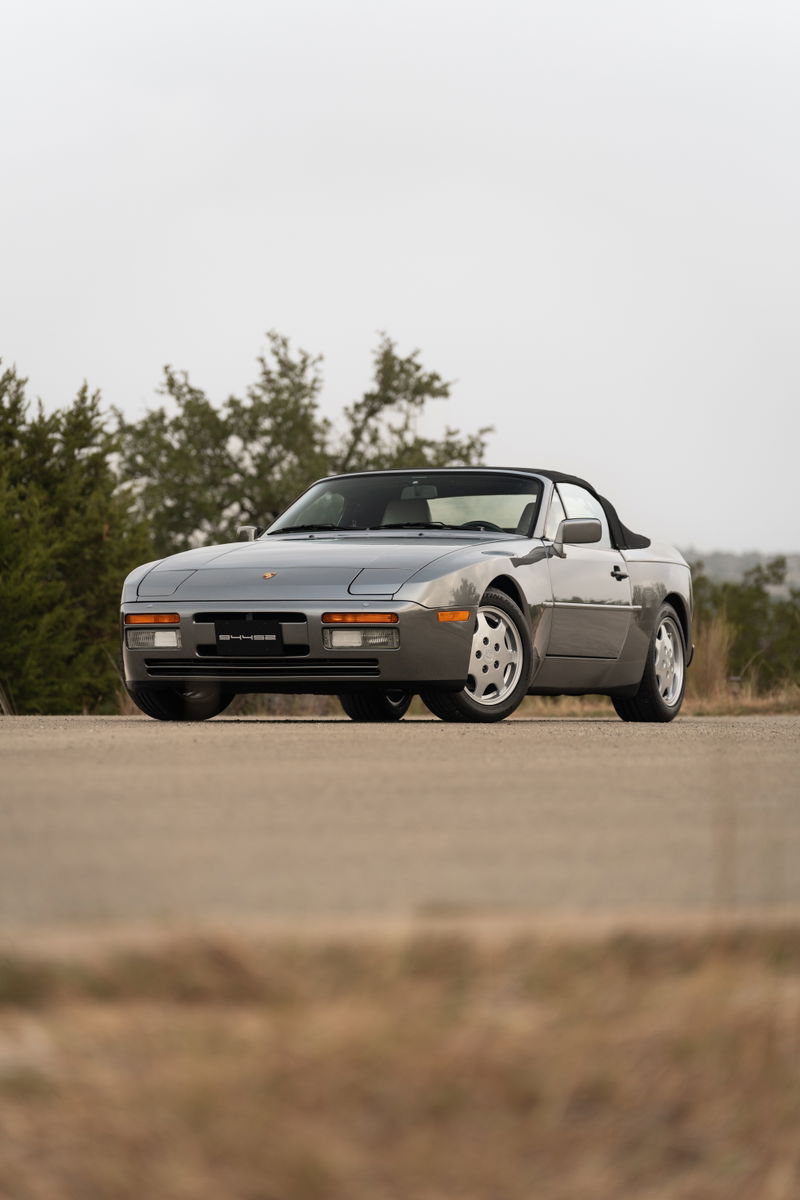 1990 Porsche 944 S2 Cabriolet in Titanium Metallic, front 3/4 view with silver alloy rims.