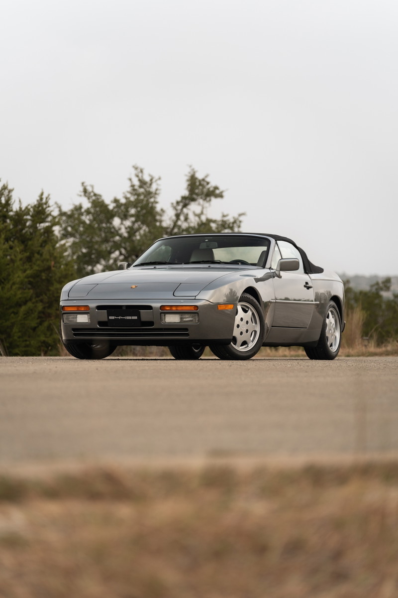 1990 Porsche 944 S2 Cabriolet in Titanium Metallic, front 3/4 view with silver alloy rims.