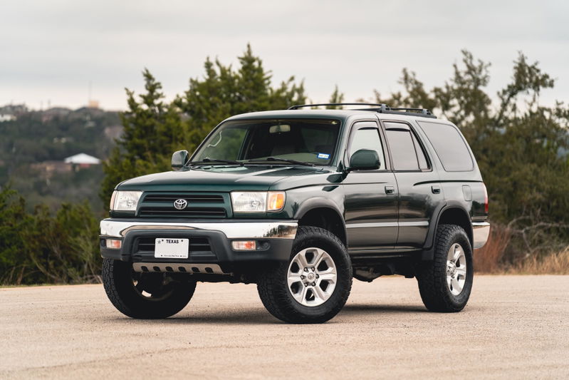 Green 2000 Toyota 4Runner with chrome trim and silver rims.