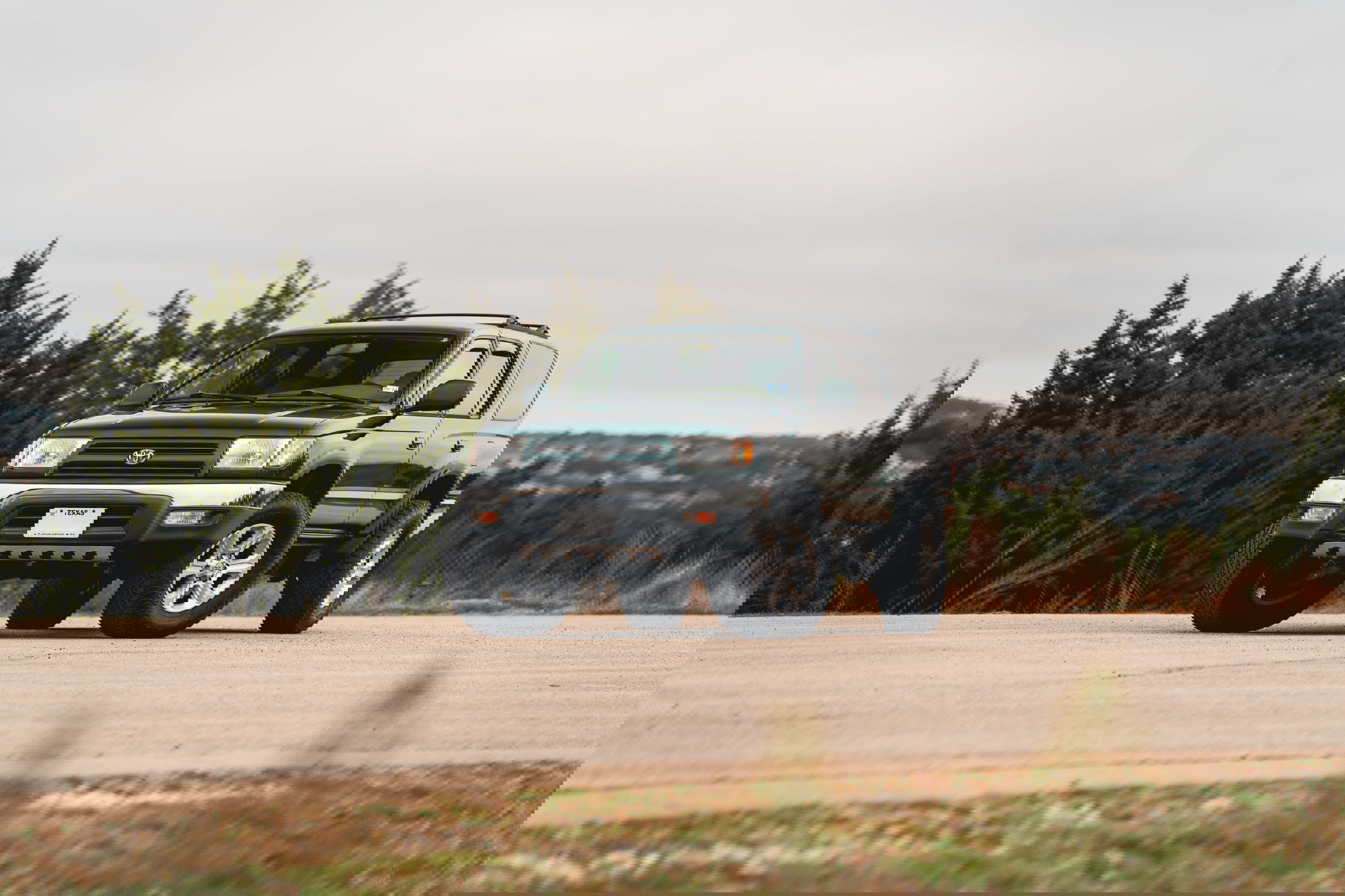 Imperial Jade Mica 2000 Toyota 4Runner with chrome trim and alloy rims on a paved road.