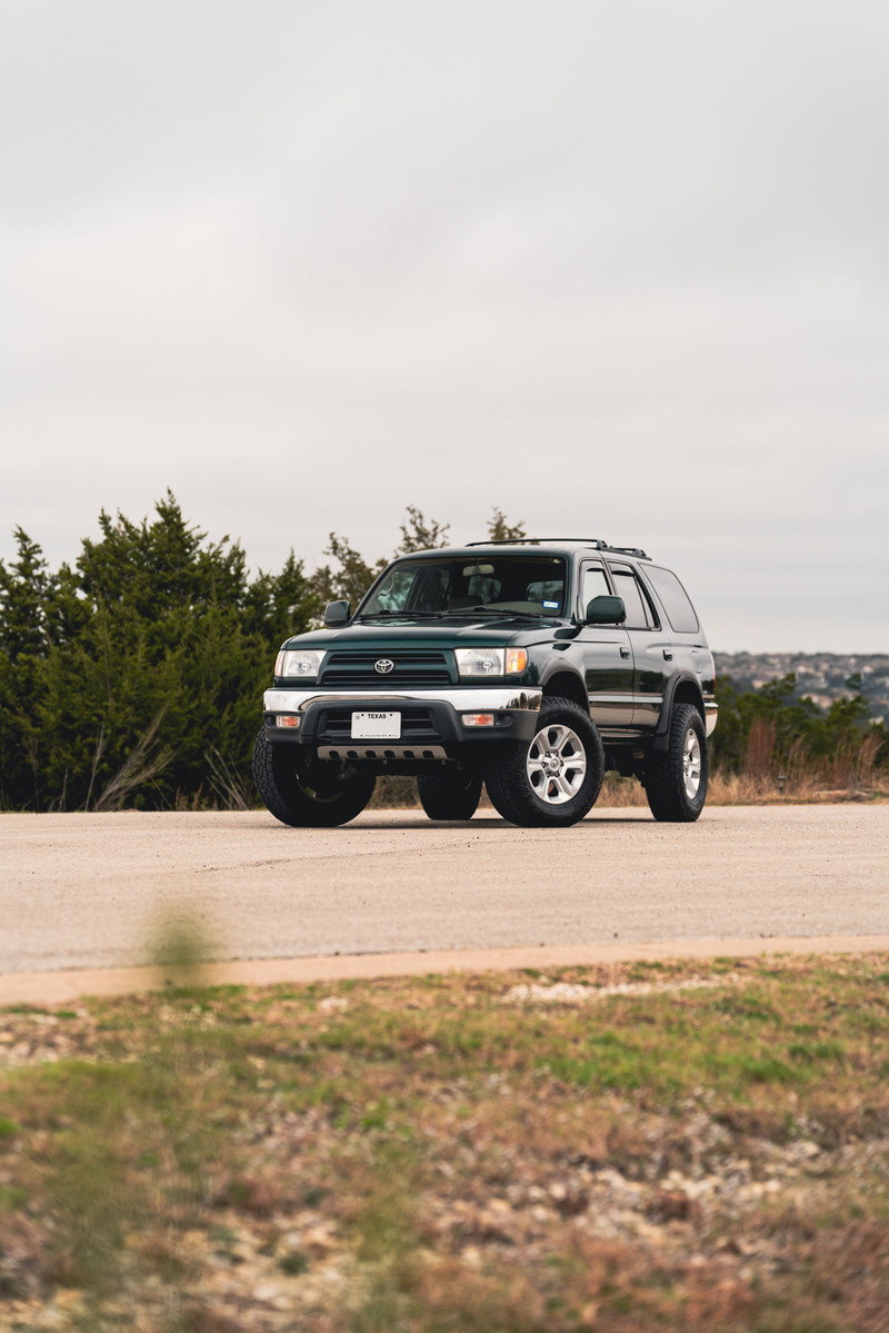 2000 Toyota 4Runner in Imperial Jade Mica, featuring chrome trim and silver alloy rims.