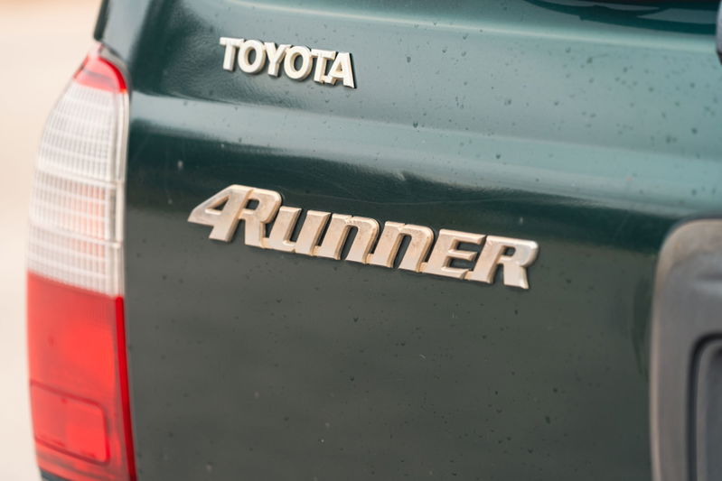 Close-up of a green 2000 Toyota 4Runner's rear badging.