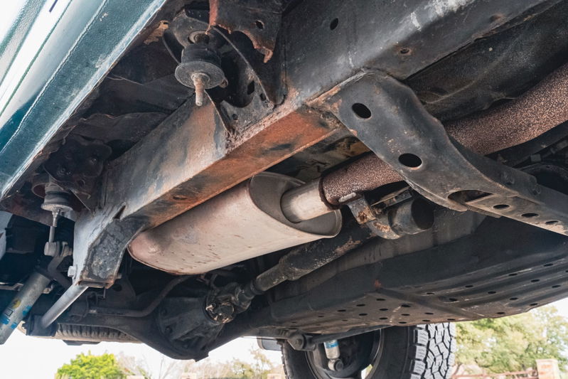 Underbody of a 2000 Toyota 4Runner with exhaust system and suspension components visible.