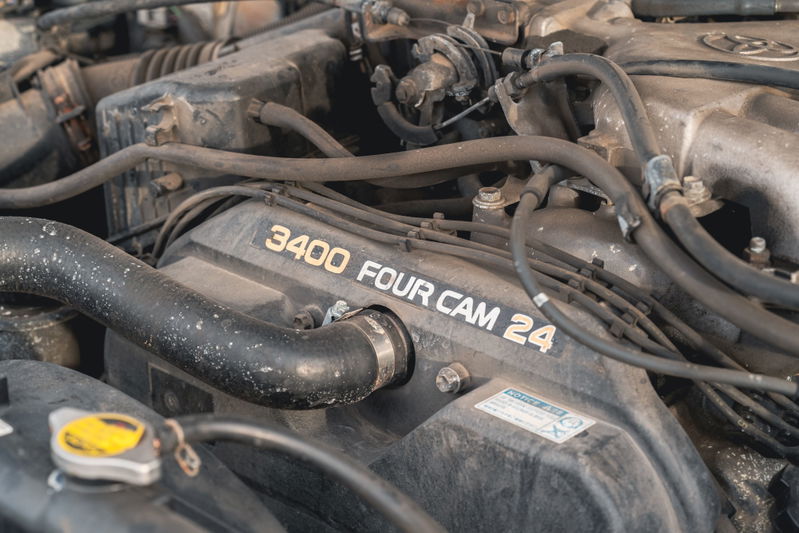 Close up of a dusty 3400 Four Cam 24 engine bay in a 2000 Toyota 4Runner.
