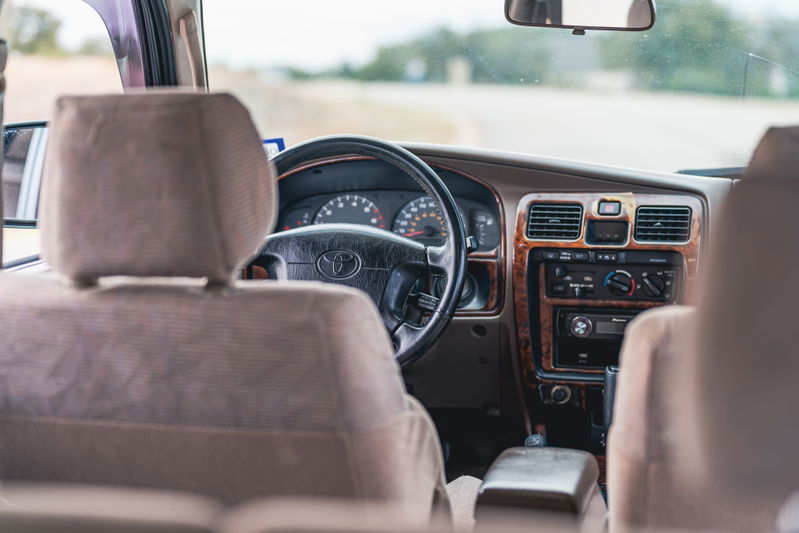 Interior view of a 2000 Toyota 4Runner with wood trim dashboard and cloth seats.