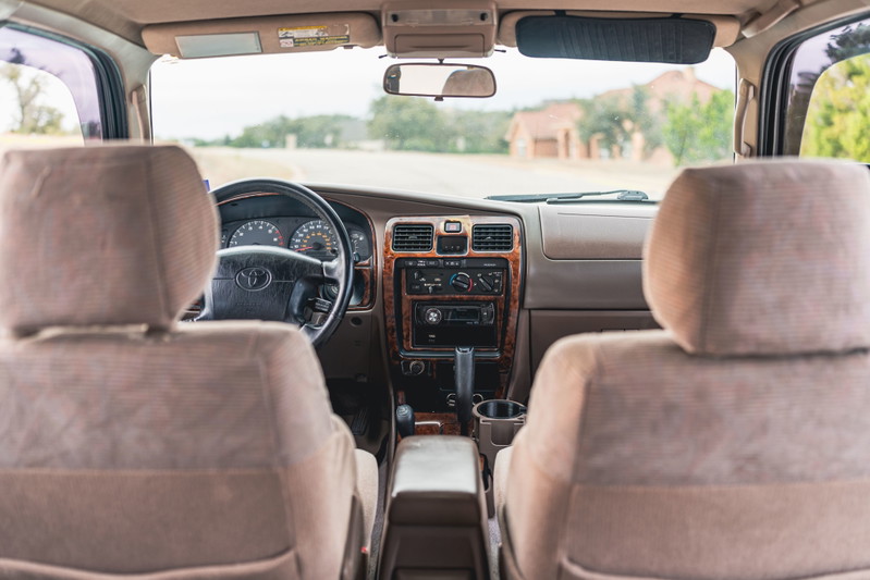 Interior of a 2000 Toyota 4Runner in Imperial Jade Mica. Front seats and dashboard visible.