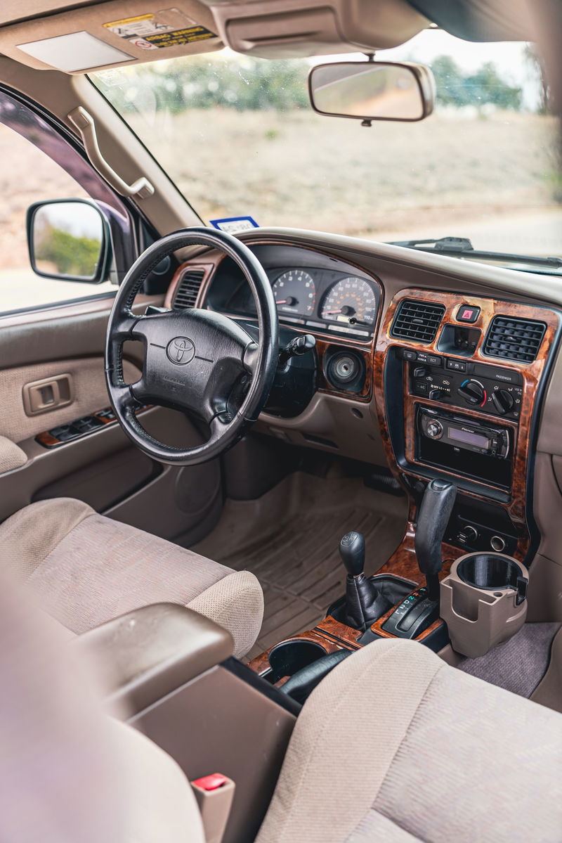 Interior of a 2000 Toyota 4Runner in Imperial Jade Mica, featuring wood trim accents.