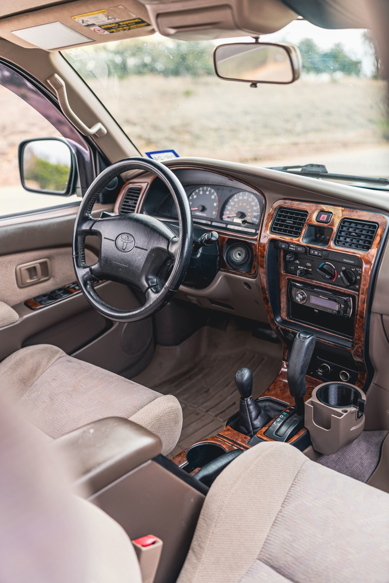 Interior of a 2000 Toyota 4Runner in Imperial Jade Mica, featuring wood trim accents.