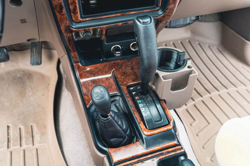 2000 Toyota 4Runner interior with wood trim, automatic shifter, and 4WD selector.