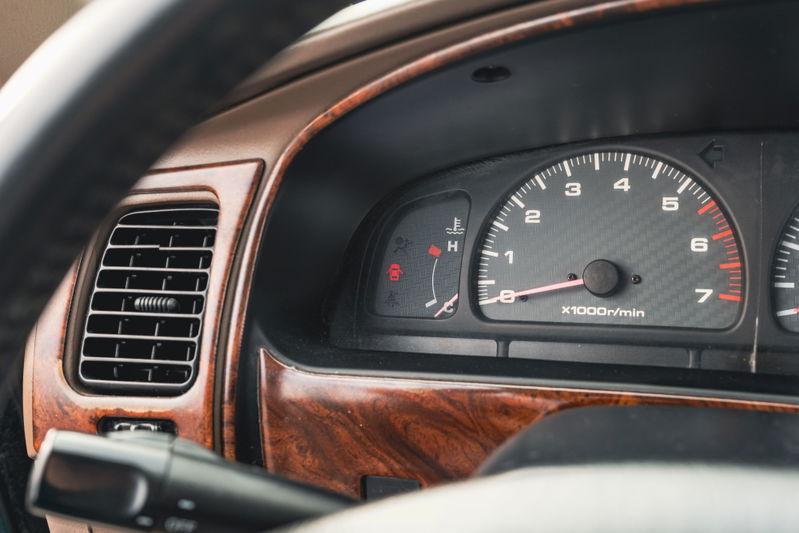 2000 Toyota 4Runner instrument cluster with wood trim, tachometer, and temperature gauge.