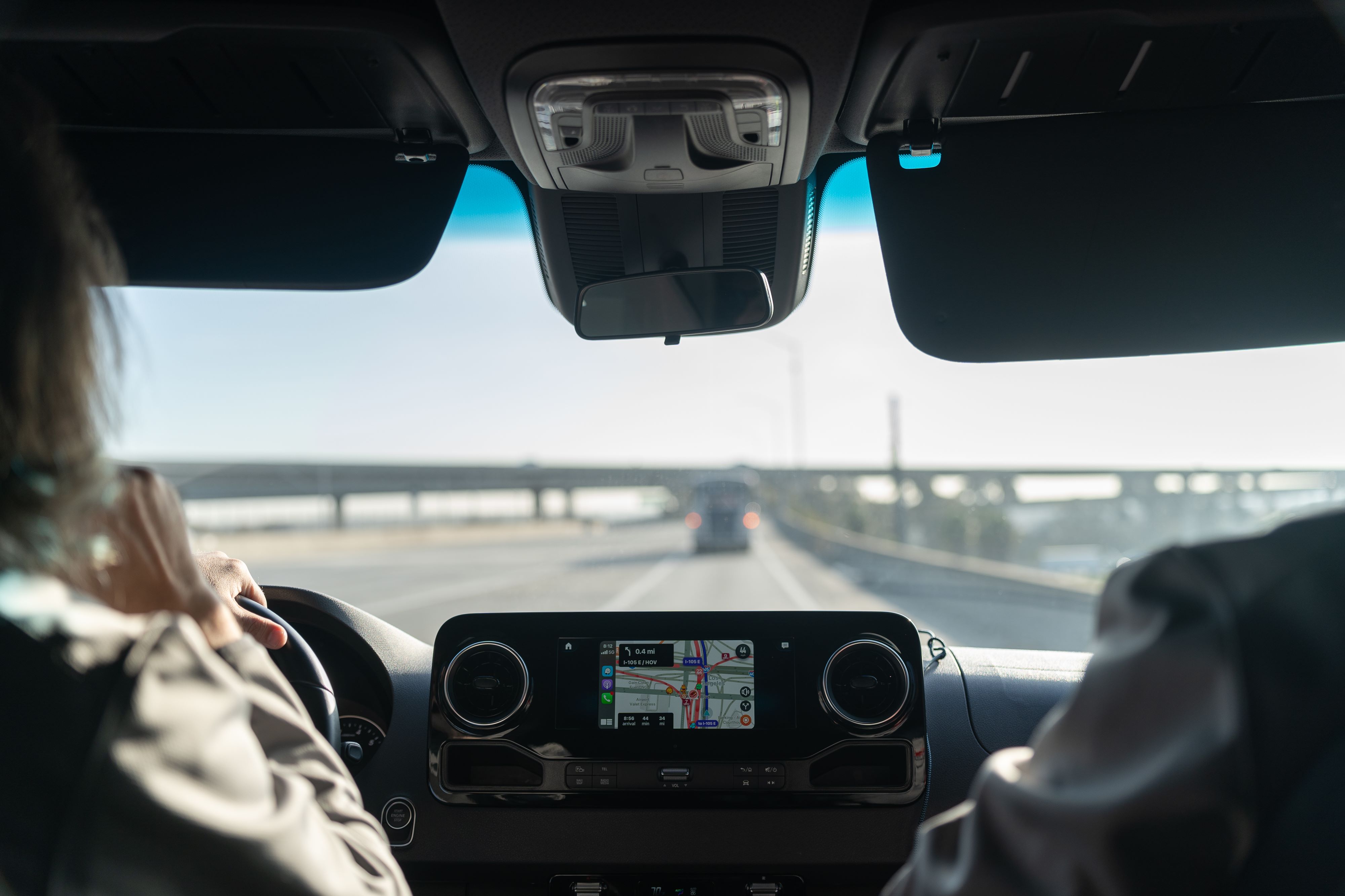 Interior view of a Mercedes-Benz Sprinter van's infotainment screen and dashboard.