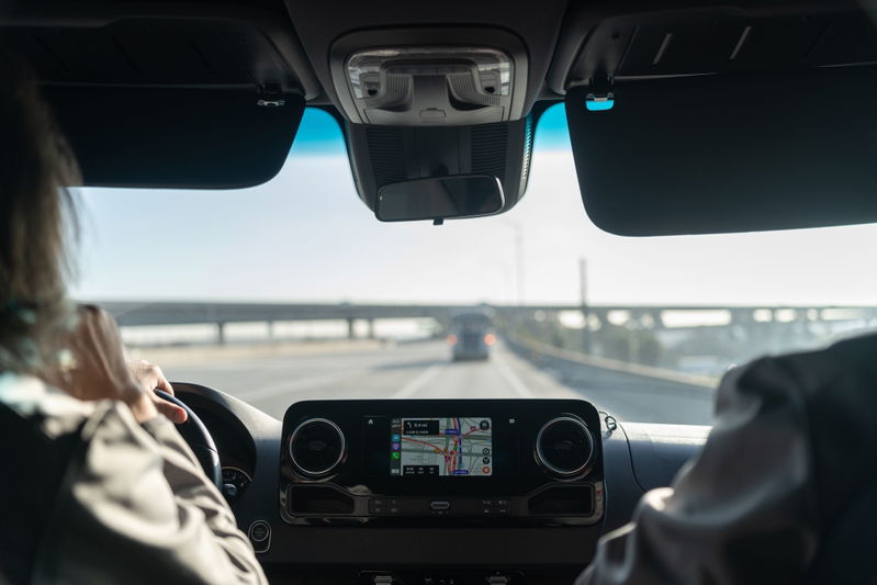 Interior view of a Mercedes-Benz Sprinter van's infotainment screen and dashboard.