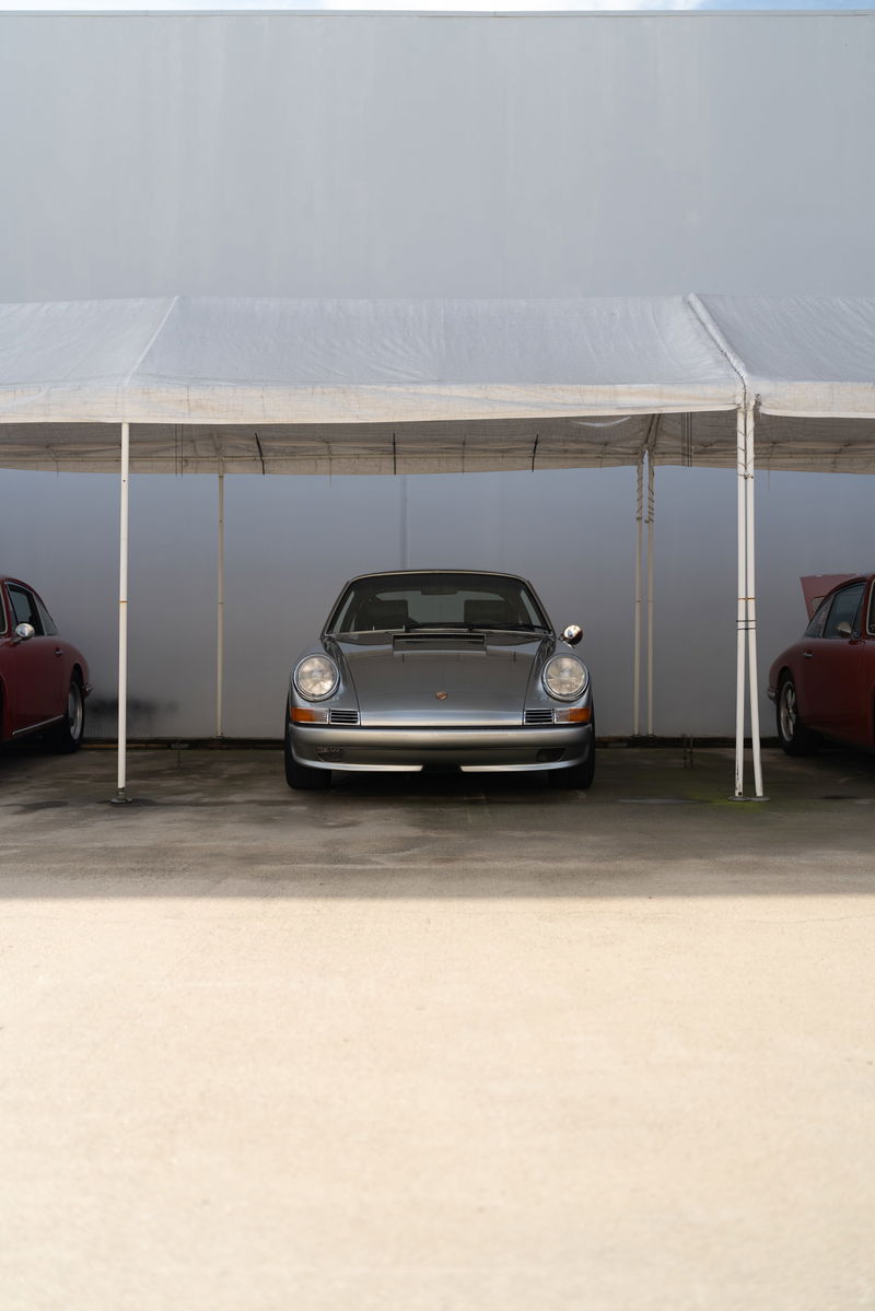 Silver Porsche 911 Targa with chrome trim under a white tent at the Lit Show LA 2024.