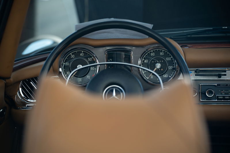 Close-up of the classic Mercedes-Benz 300SL's dashboard with a tan interior.