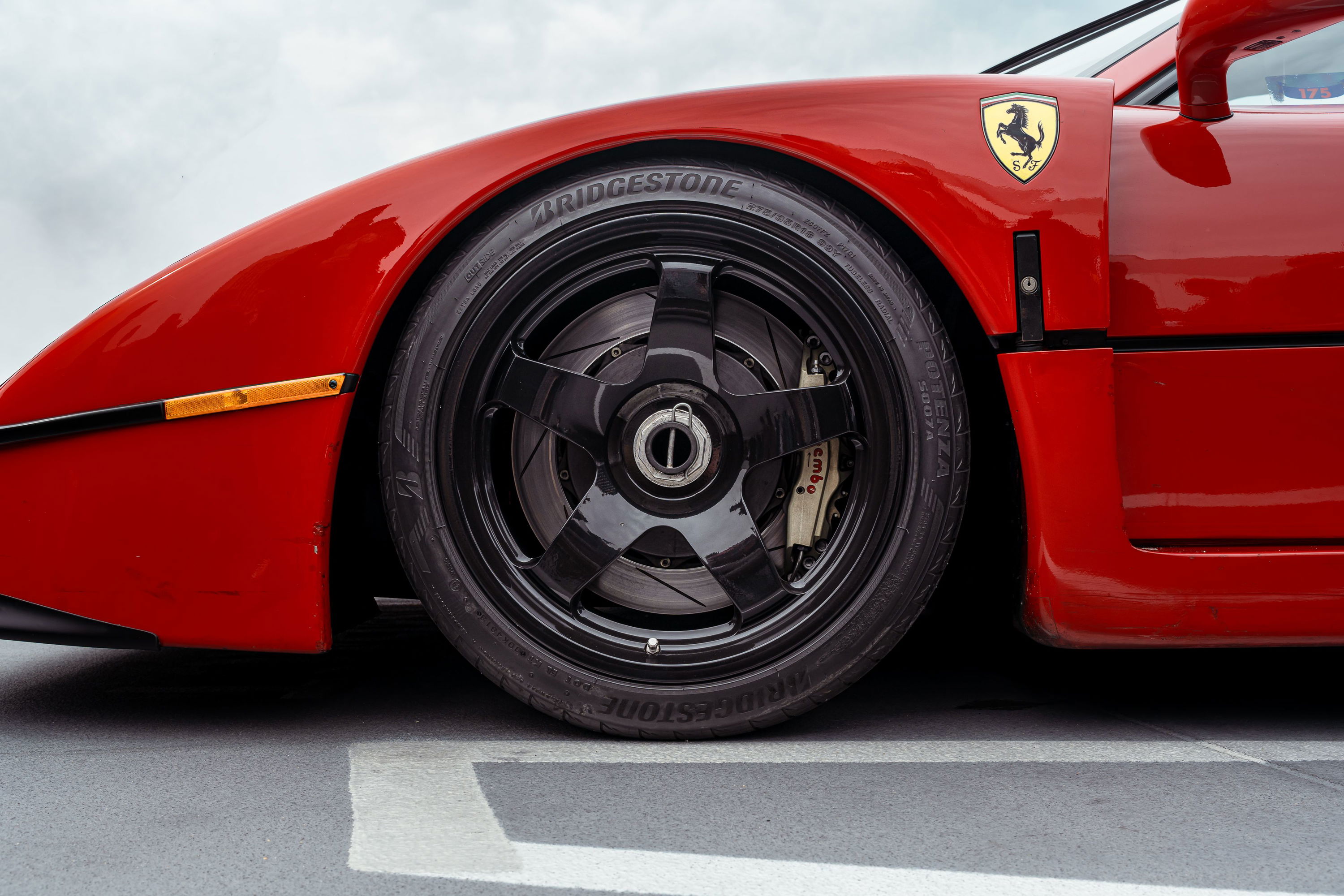 Red Ferrari F40 with black Speedline rims and Bridgestone tires.