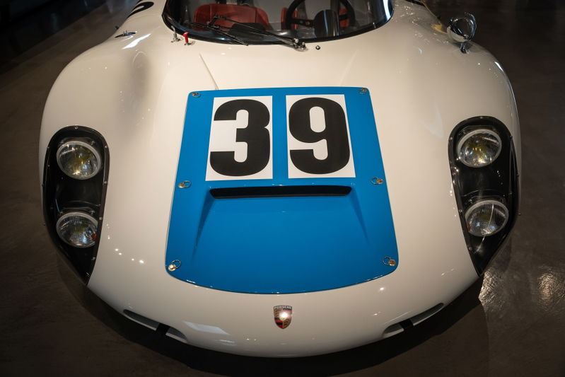 Vintage race car with white body, blue stripe, and "39" livery.