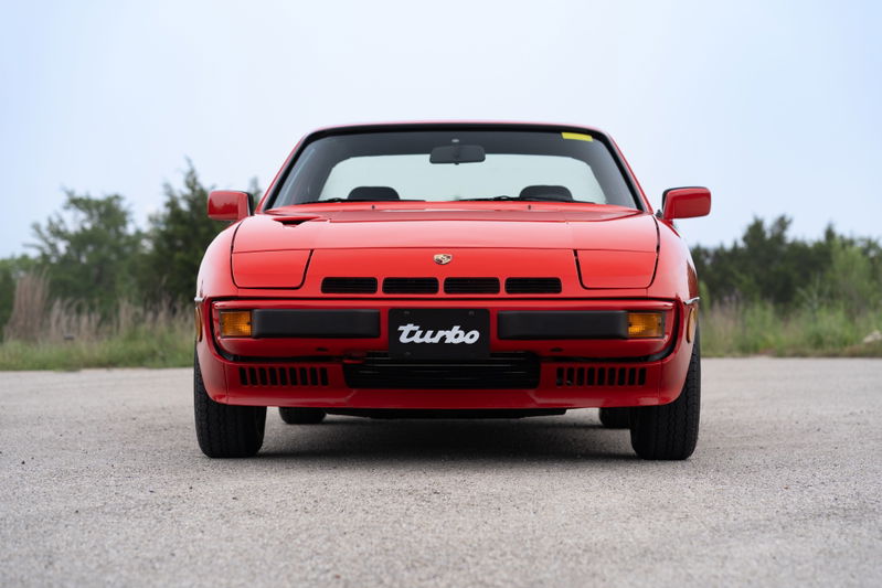 Front view of a Guards Red 1981 Porsche 924 Turbo, featuring black trim and the "Turbo" badge.