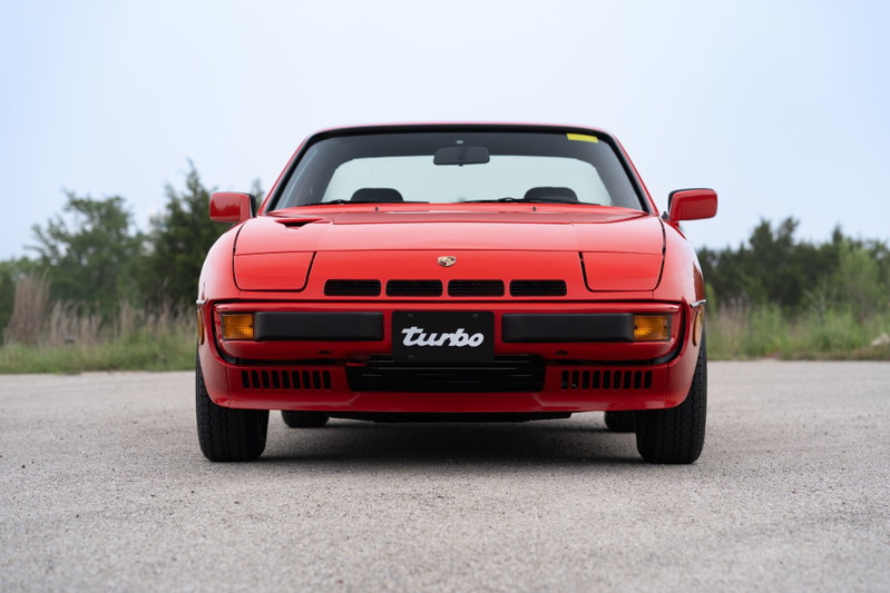Front view of a Guards Red 1981 Porsche 924 Turbo, featuring black trim and the "Turbo" badge.