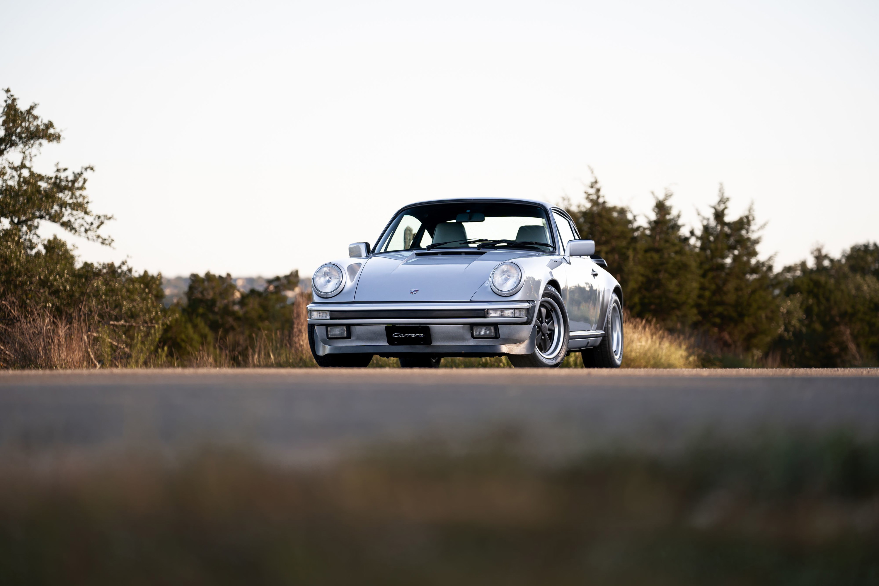 Silver metallic 1987 Porsche 911 Carrera G50 front view with black Fuchs rims.