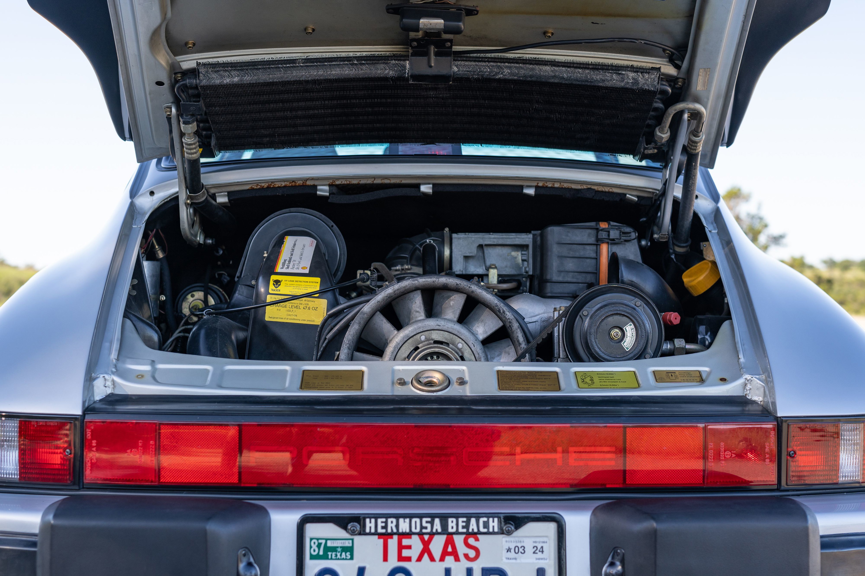 Silver 1987 Porsche 911 Carrera G50 engine bay with exposed flat-six engine, fan, and air intake.