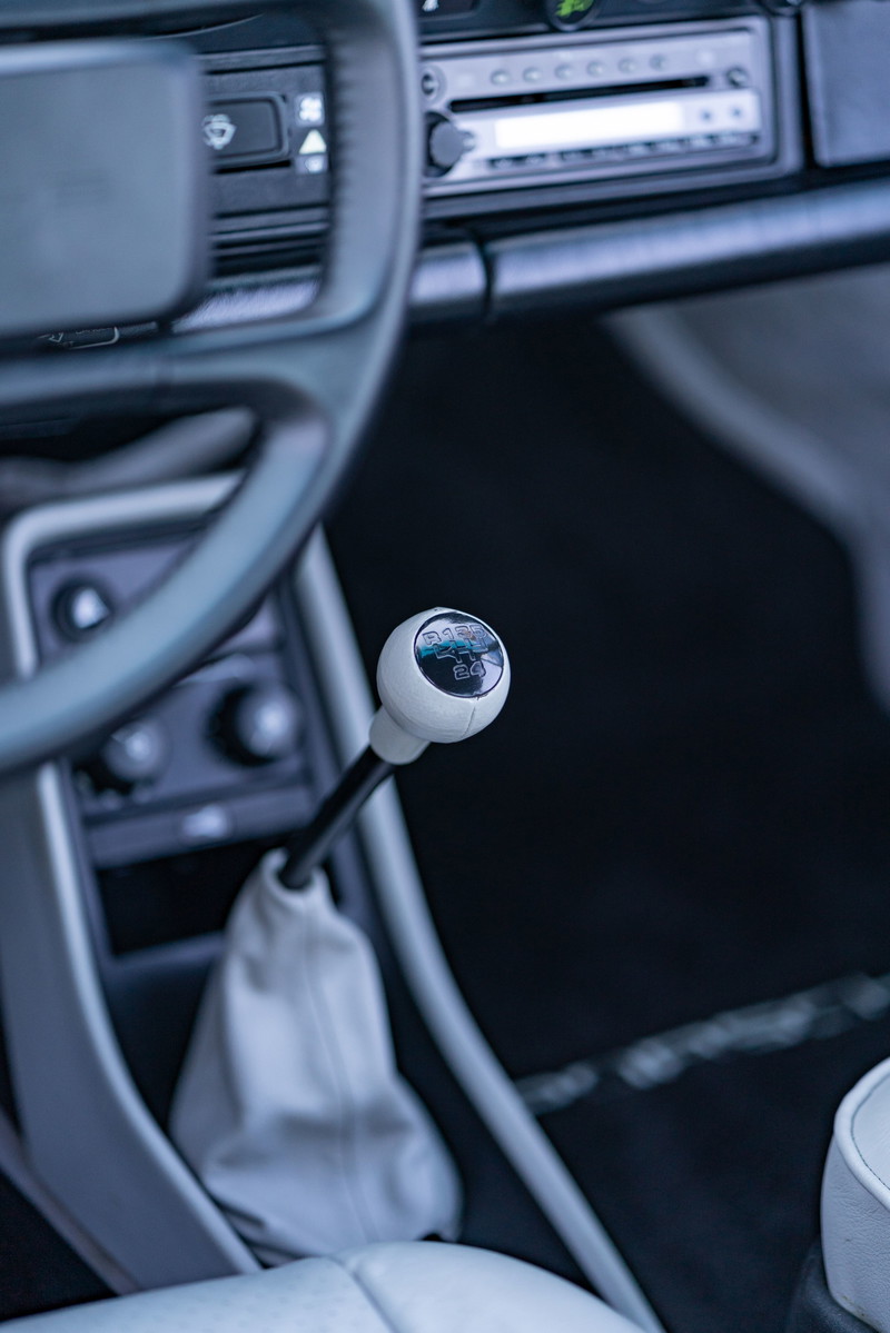 Silver 1987 Porsche 911 Carrera G50 with white shift knob and boot.