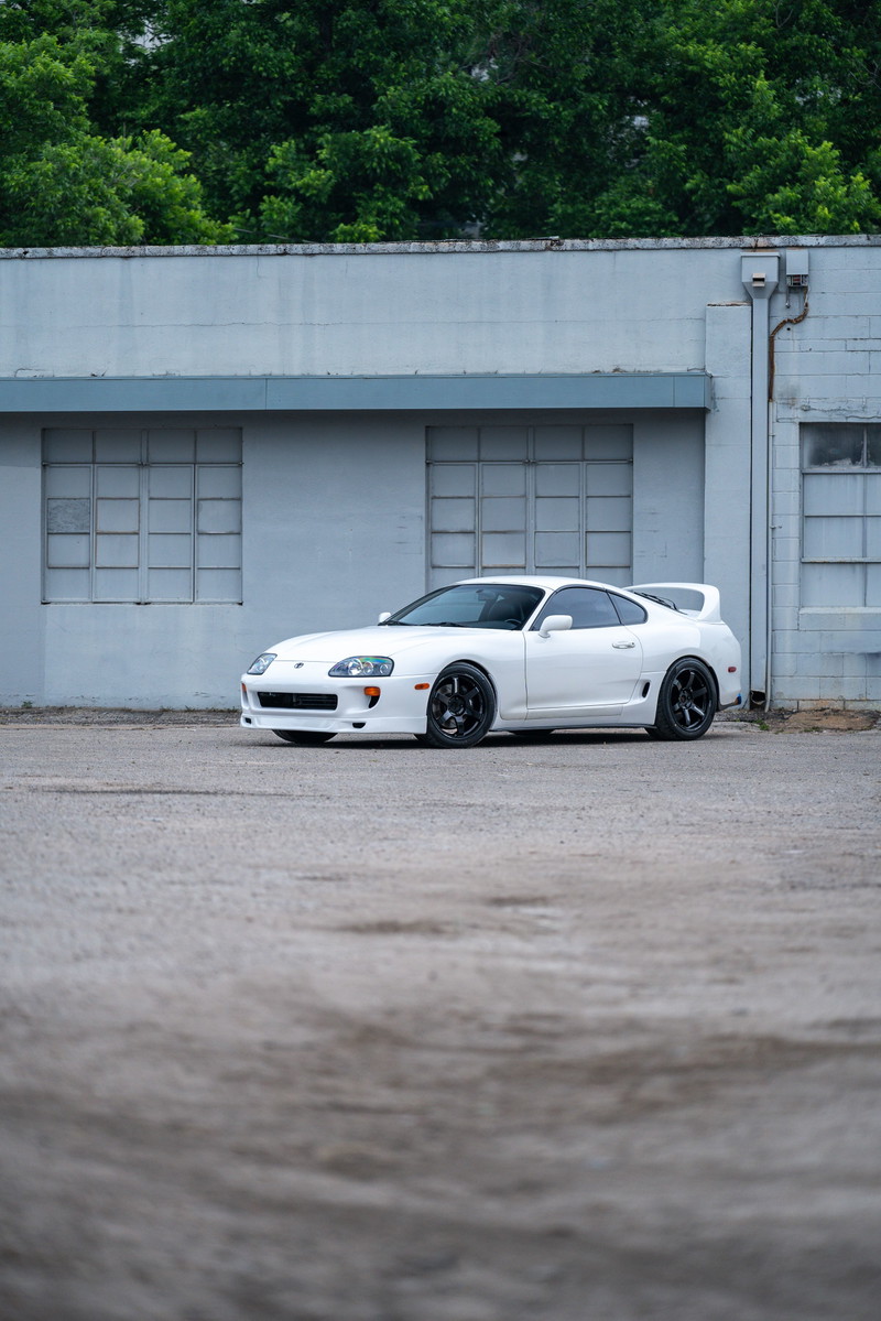 White 1994 Toyota Supra T56 with black rims and body-colored trim.