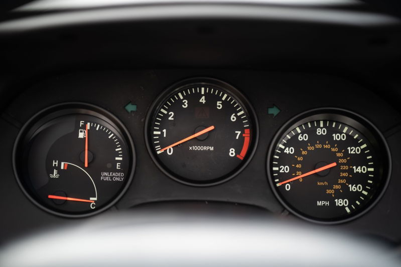 1994 white Toyota Supra dashboard gauges: tachometer, speedometer, fuel, and temp.
