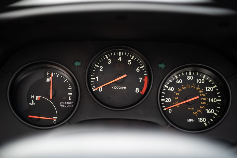 1994 white Toyota Supra dashboard gauges: tachometer, speedometer, fuel, and temp.