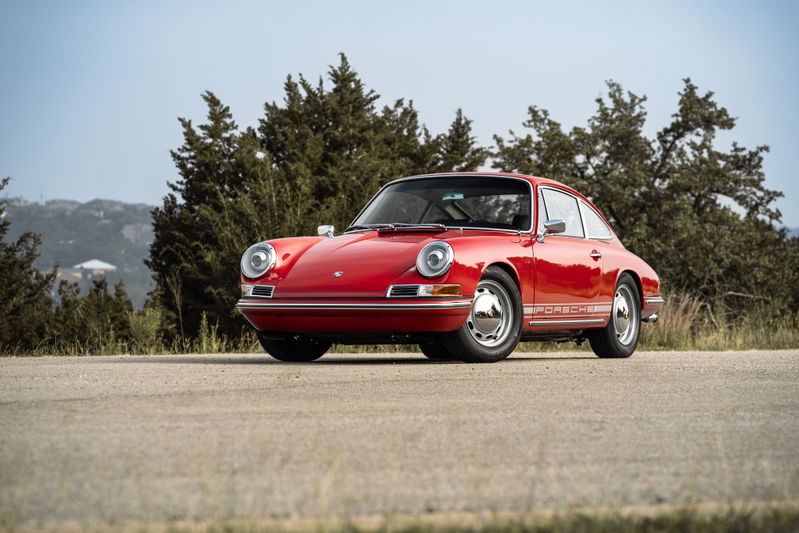 1967 Porsche 912 Coupe in Polo Red, with chrome trim and classic rims.