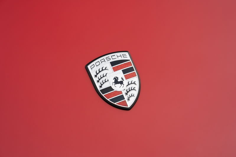 Porsche crest on the red hood of a 1967 Porsche 912 Coupe.