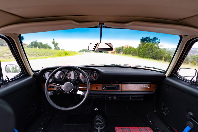 1967 Porsche 912 coupe interior: wooden trim, five-gauge dash, plaid seats.