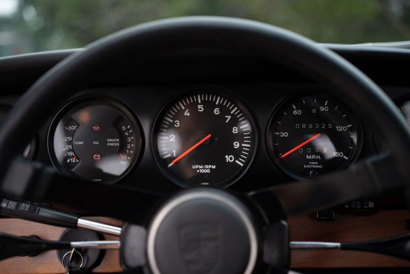 1967 Porsche 912 coupe instrument cluster with tachometer, speedometer, and oil/temp gauges.