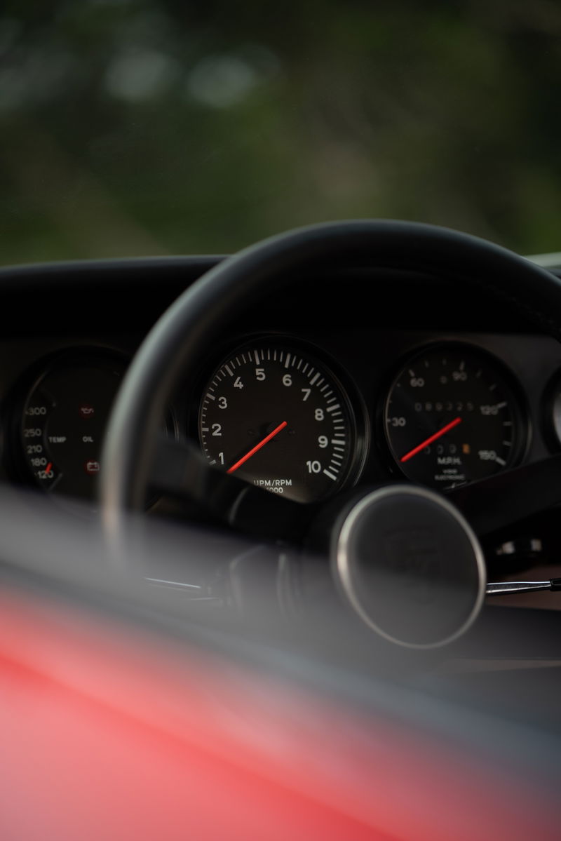 1967 Porsche 912 coupe dashboard: tachometer, speedometer, oil temp gauge, and steering wheel.