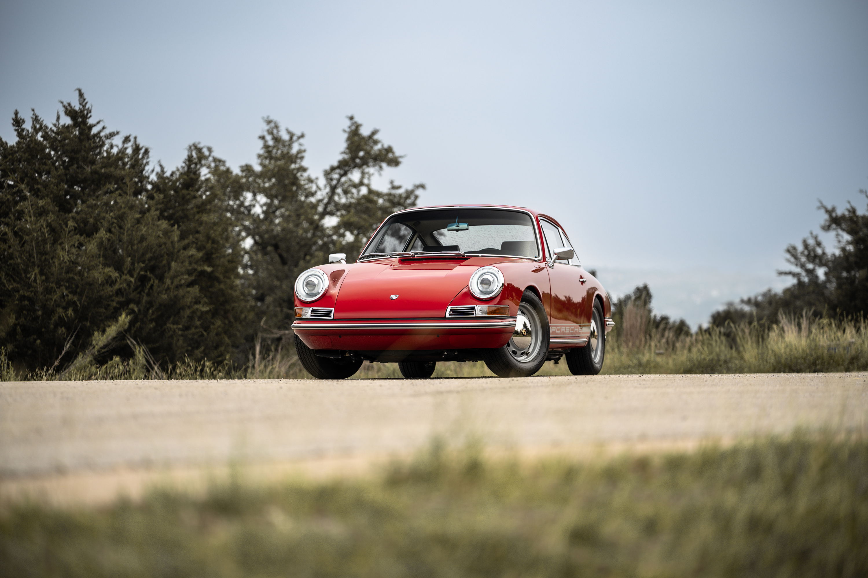 A Polo Red 1967 Porsche 912 6-Coupe with chrome Fuchs wheels.