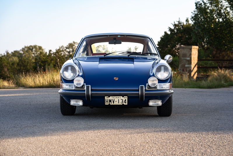 Front view of a blue 1969 Porsche 911S, featuring chrome bumpers and classic rims.