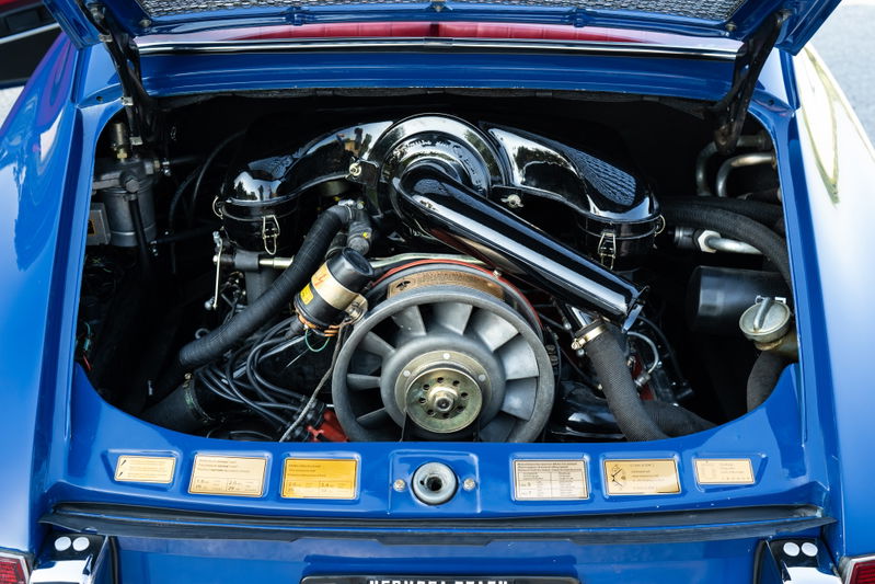 1969 Porsche 911S engine bay in Ossi blue. Air-cooled flat-six engine with cooling fan.