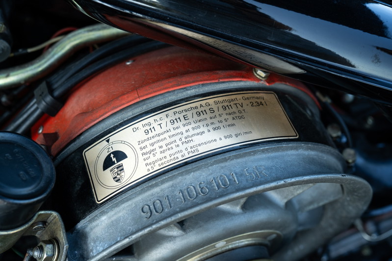 Close-up of a 1969 Porsche 911S engine bay, showing an engine ID plate and fan shroud.